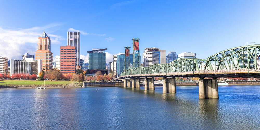 Steel,Bridge,Over,Water,With,Cityscape,And,Skyline,In,Portland